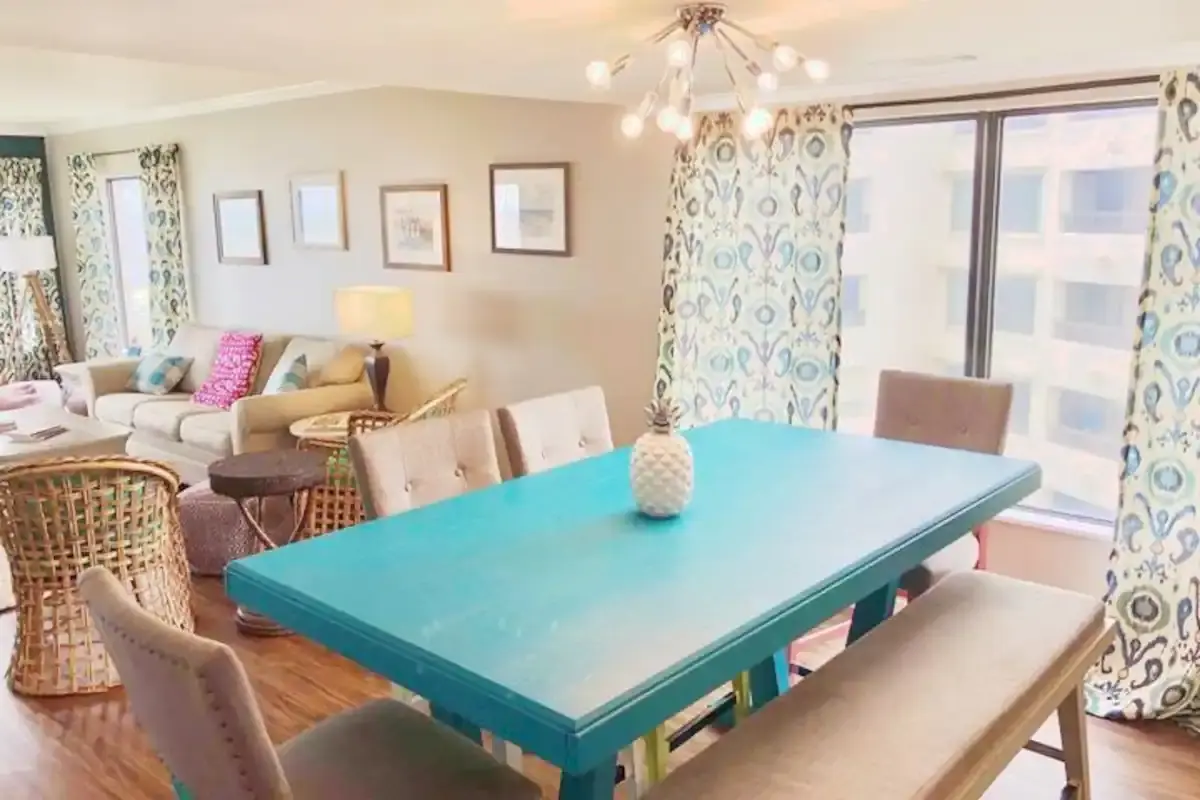 Turquoise dining table in a bright coastal living room