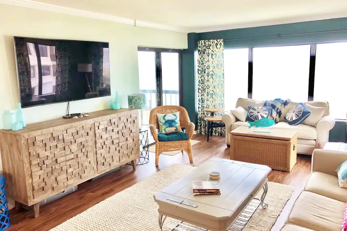Coastal living room with blue seating and a wall-mounted television