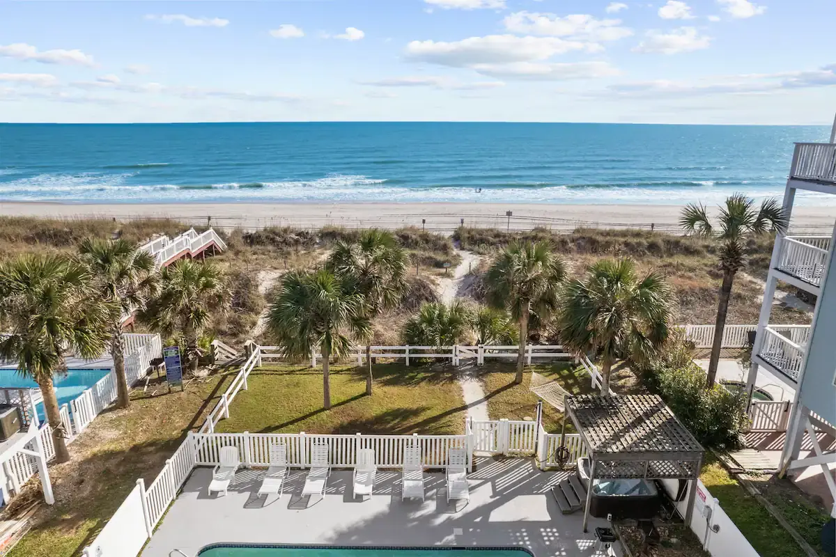Aerial view of an oceanfront vacation property and beach